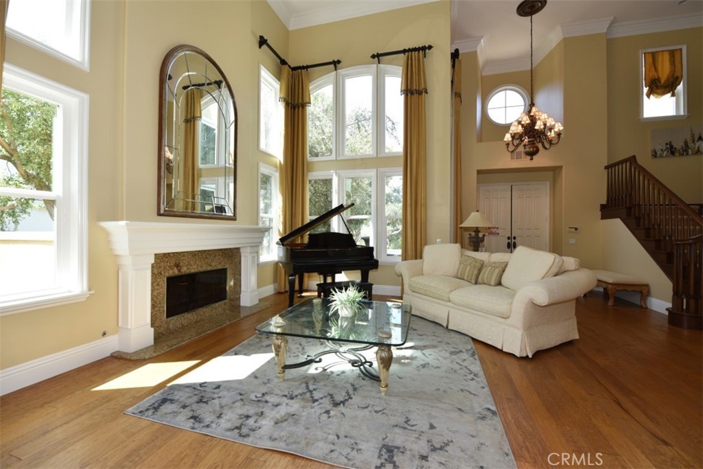 12 Brigadier Irvine, CA 92603 - Photo 5 of 50 a living room with furniture a fireplace and a floor to ceiling window