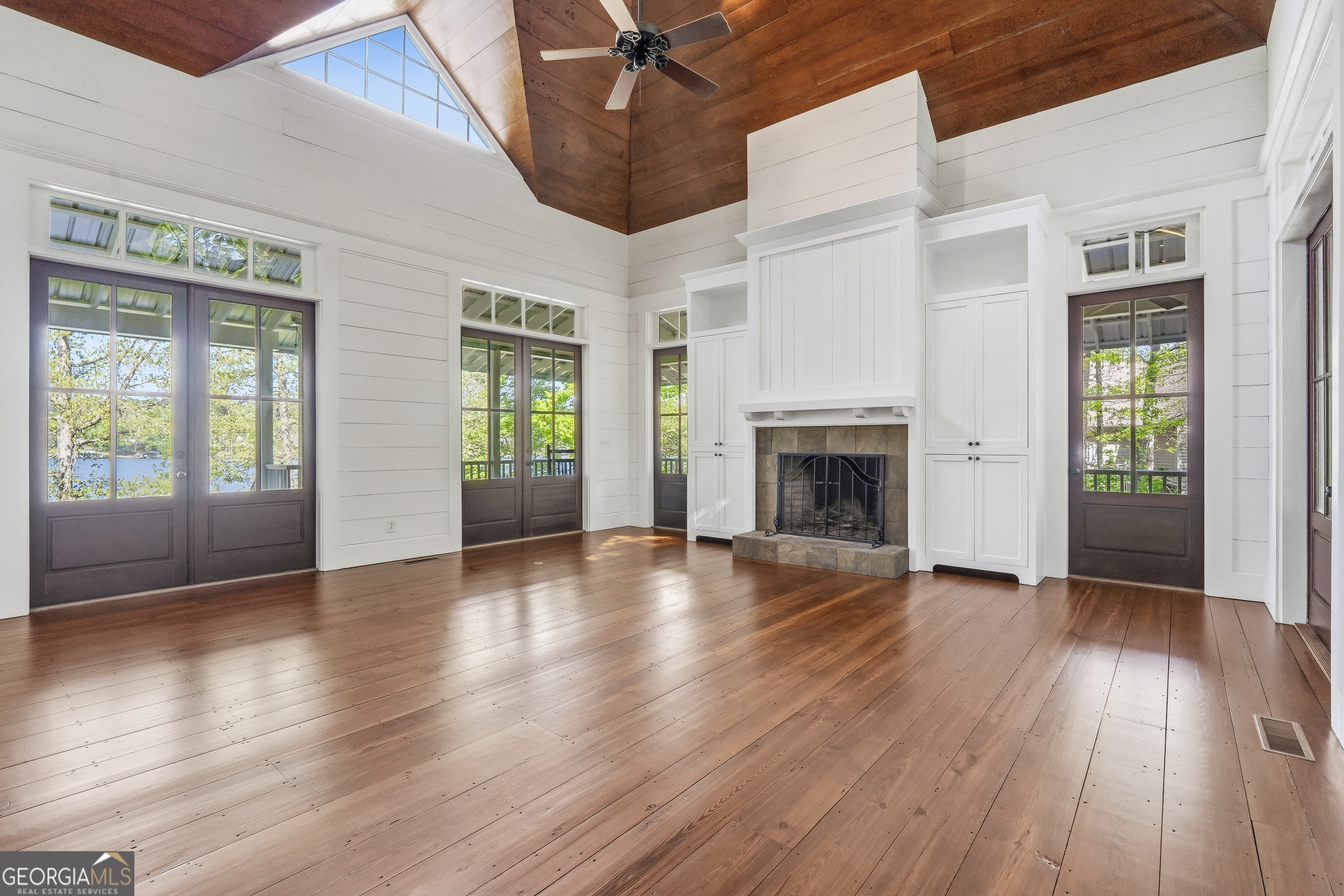 57 Birch Lane Sparta, GA 31087 - Photo 13 of 61 an empty room with wooden floor fireplace and windows