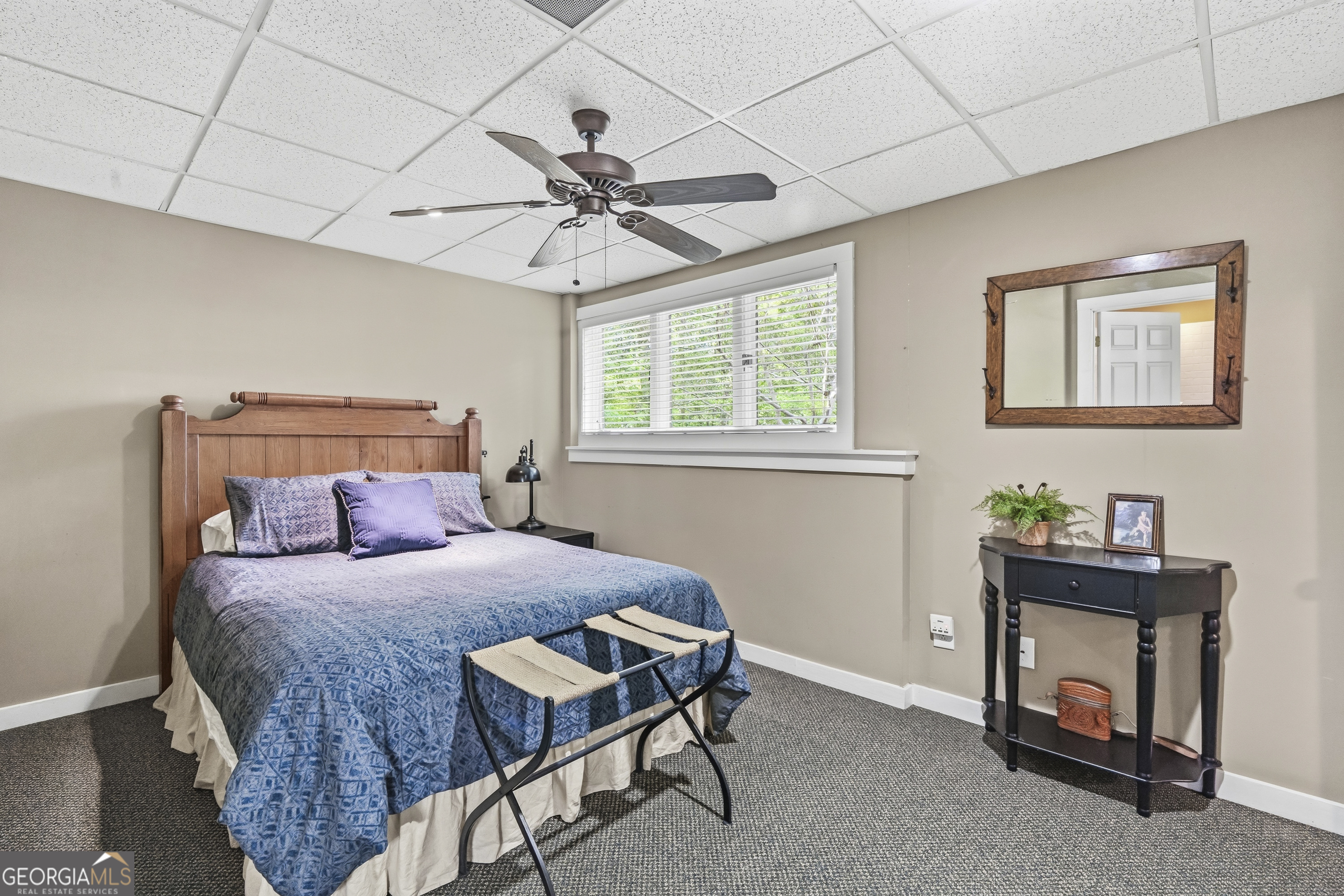 57 Birch Lane Sparta, GA 31087 - Photo 48 of 61 a bedroom with a bed and a chandelier