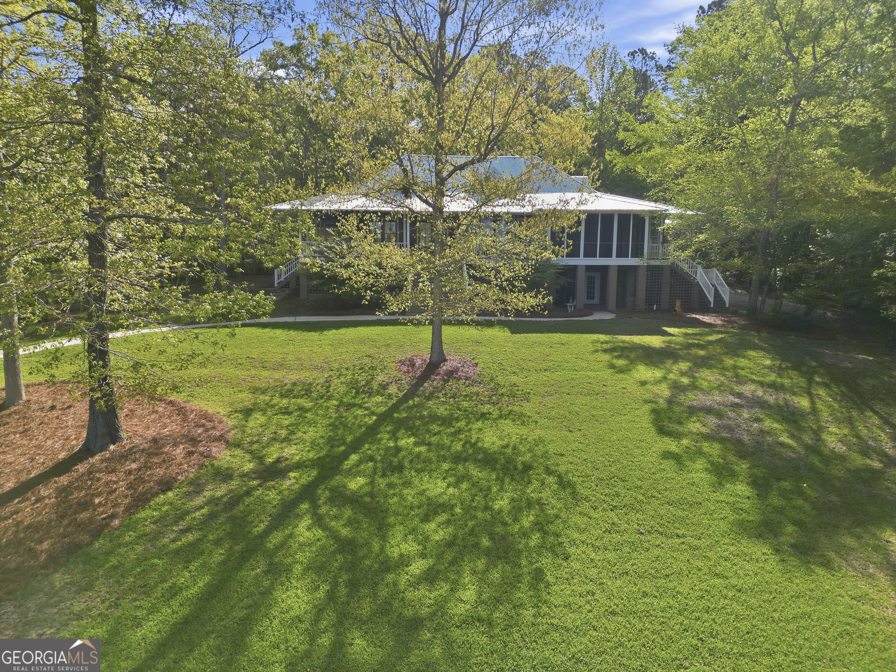 57 Birch Lane Sparta, GA 31087 - Photo 61 of 61 a backyard of a house with lots of green space and fountain