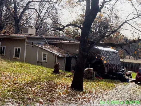 a backyard of a house with table and chairs