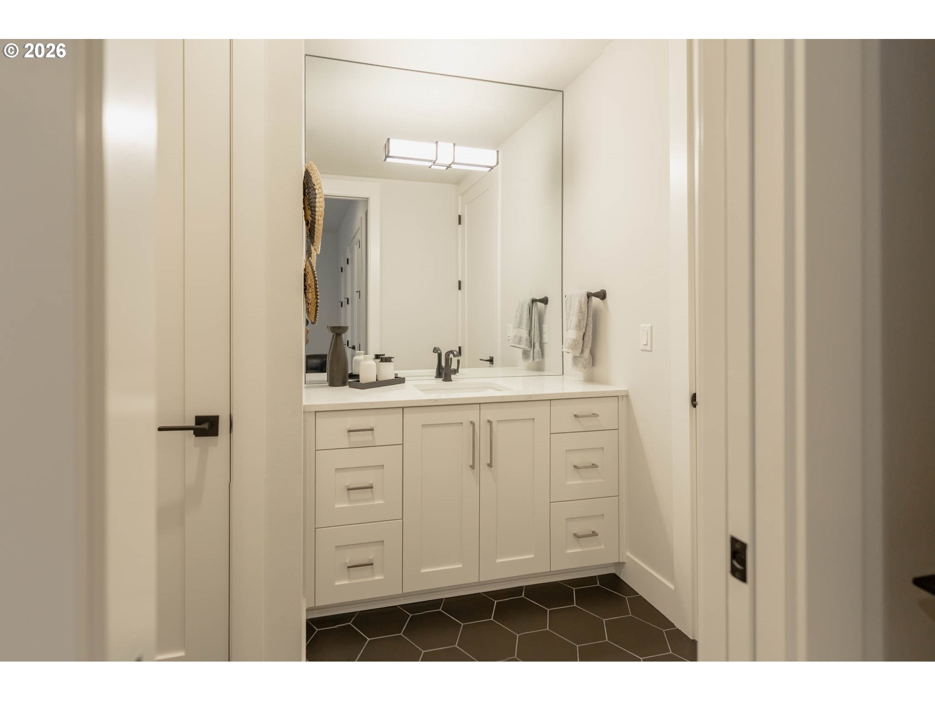 4560 Southwest 59th Avenue Portland, OR 97221 - Photo 22 of 30 a bathroom with a sink and a mirror