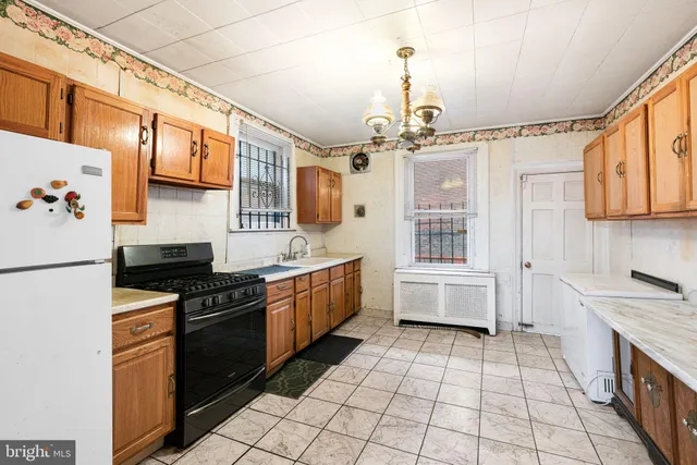 a kitchen with stainless steel appliances a stove a sink and a refrigerator