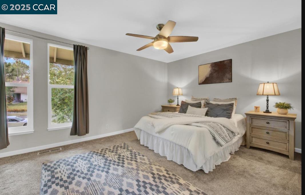 5434 Roundtree Court, Unit C Concord, CA 94521 - Photo 20 of 23 a bedroom with a large bed and a window