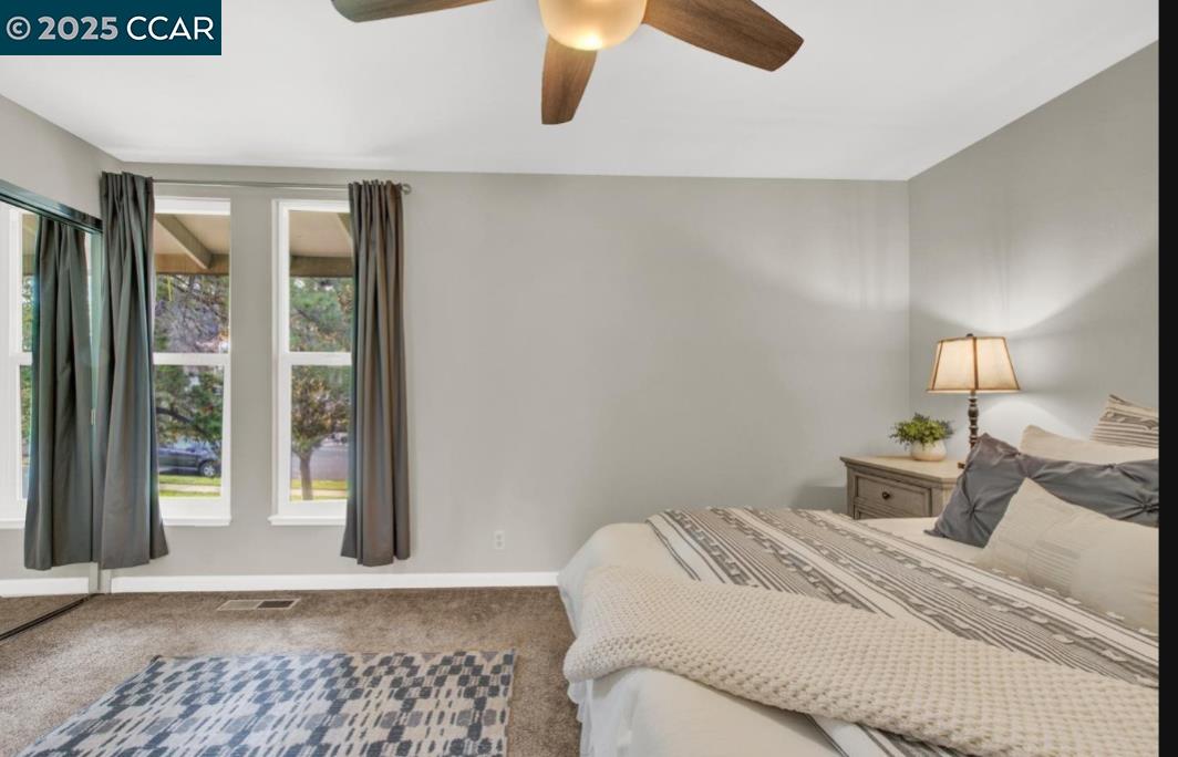 5434 Roundtree Court, Unit C Concord, CA 94521 - Photo 21 of 23 a bedroom with a bed and wooden floor