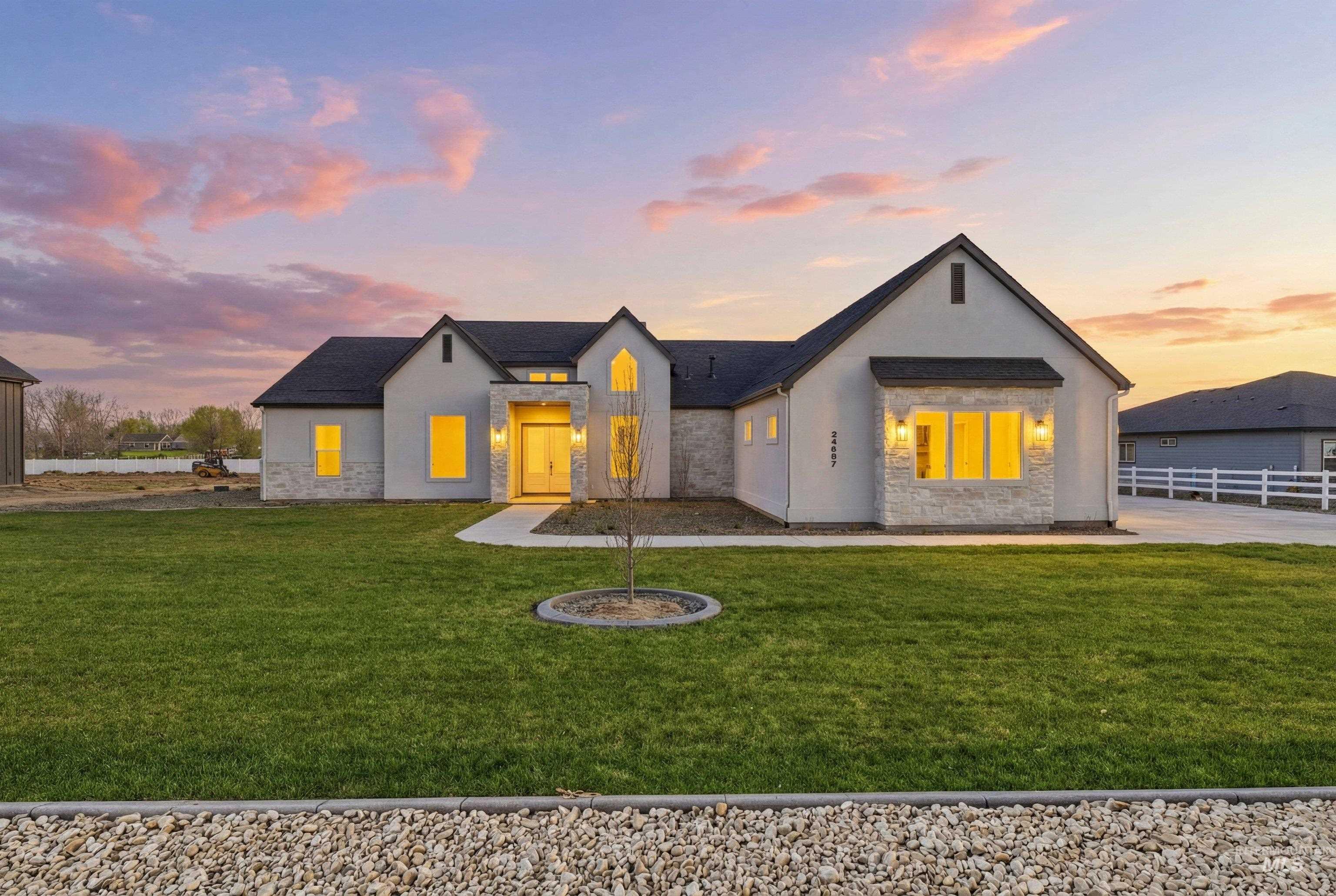 View of front of house with stone siding and stucco siding
