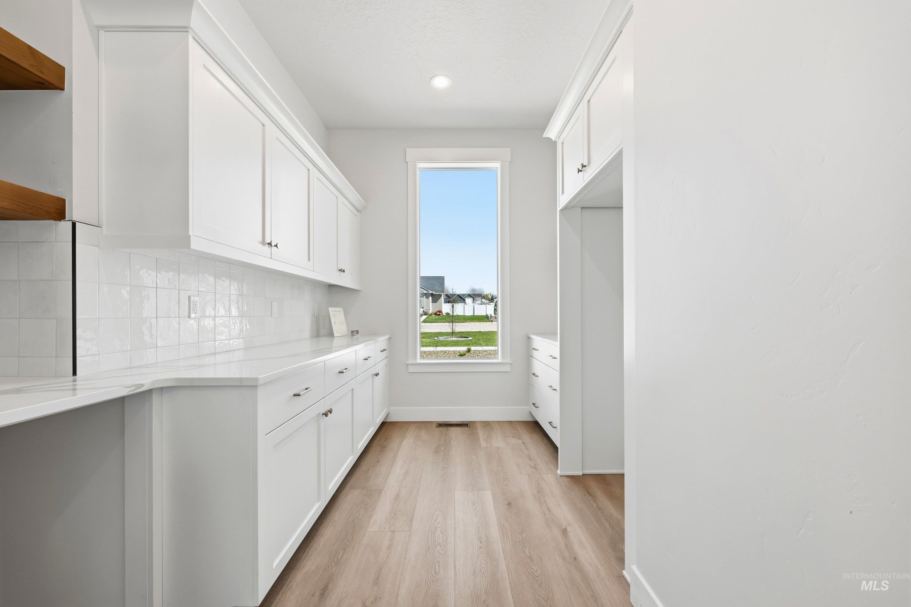 24897 Ardmore Court Caldwell, ID 83607 - Photo 18 of 47 Laundry room with baseboards and light wood-style floors