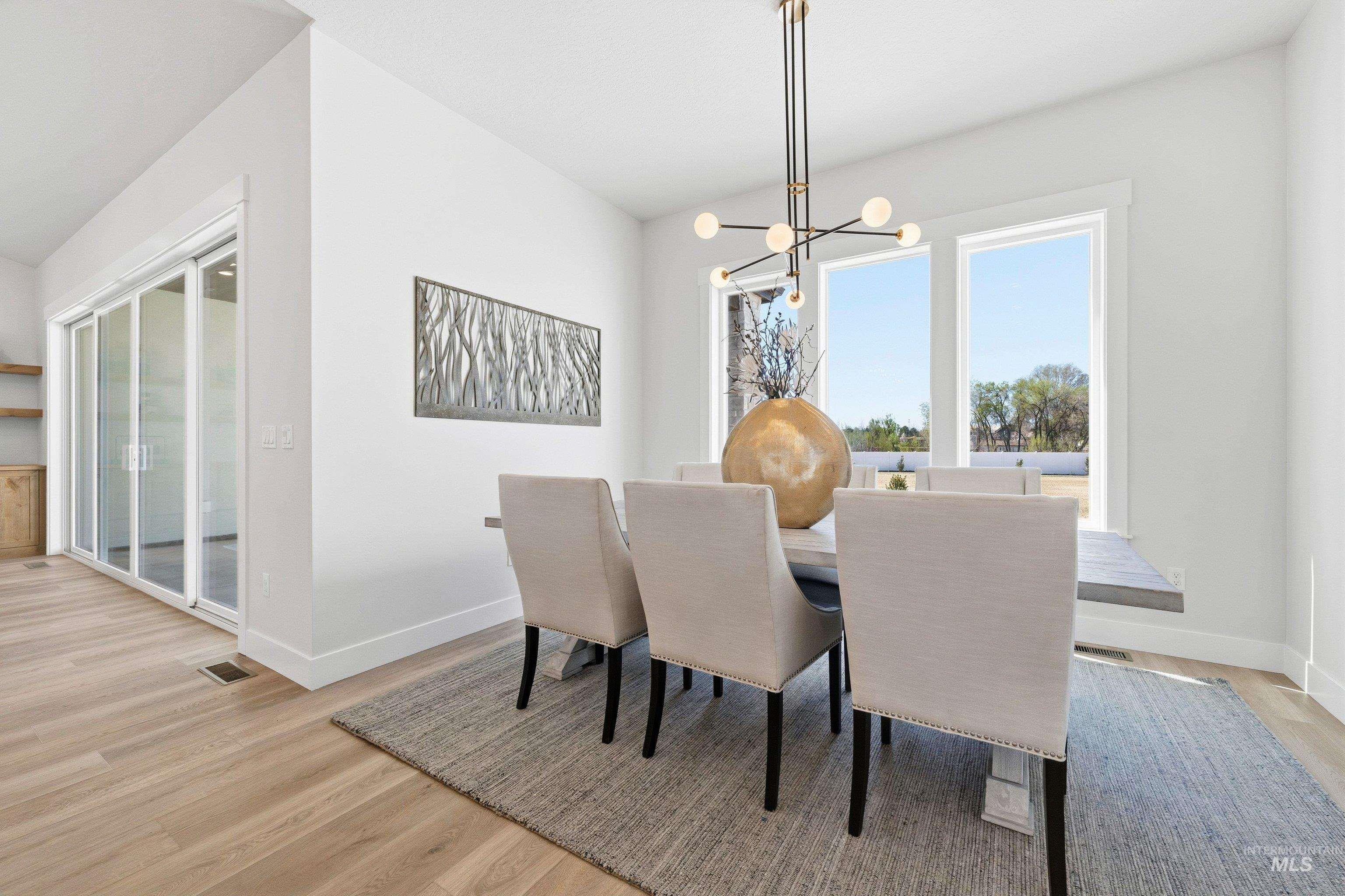 24897 Ardmore Court Caldwell, ID 83607 - Photo 21 of 47 Dining space with light wood-style flooring and hanging lights