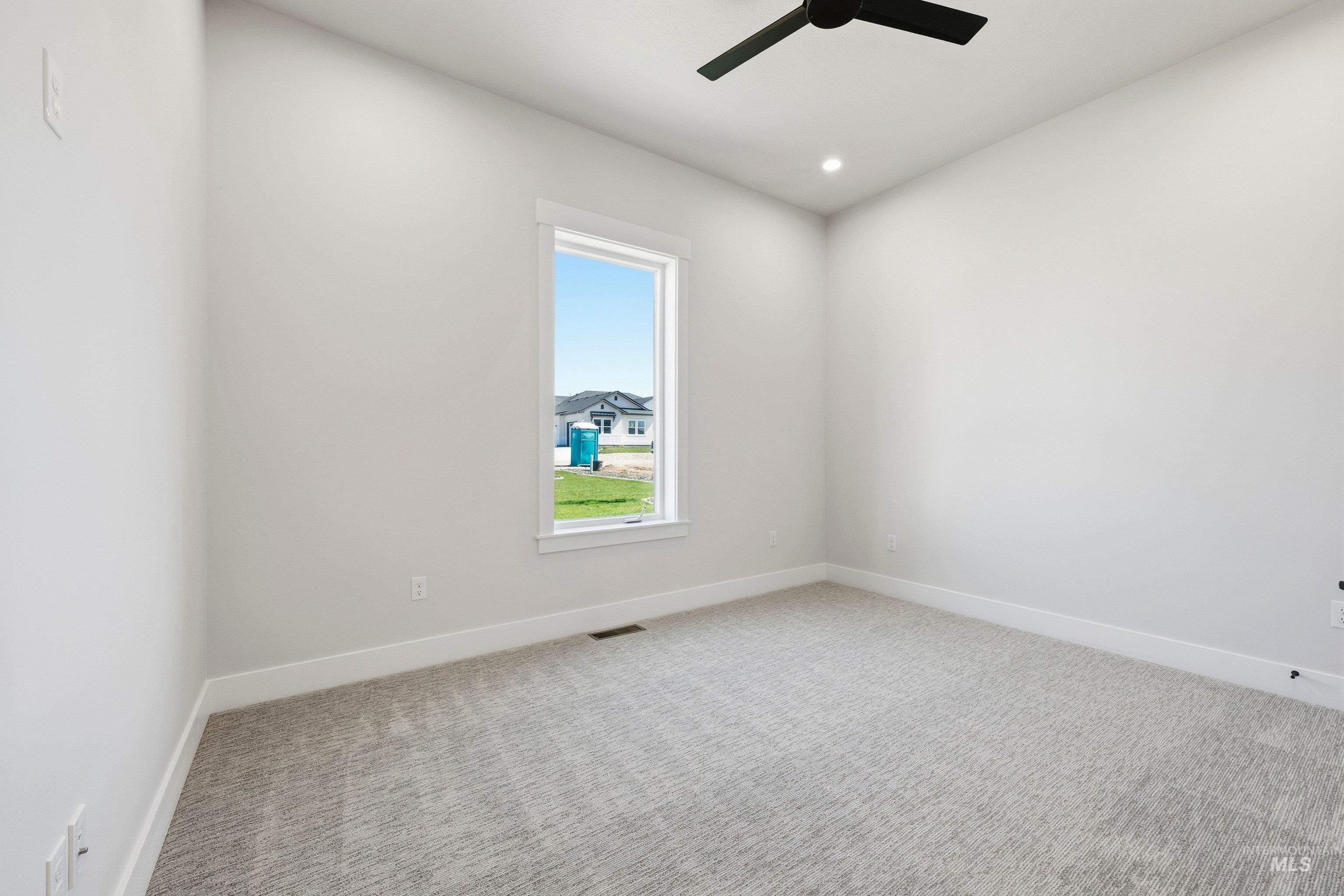 24897 Ardmore Court Caldwell, ID 83607 - Photo 29 of 47 Empty room featuring light carpet, recessed lighting, and a ceiling fan