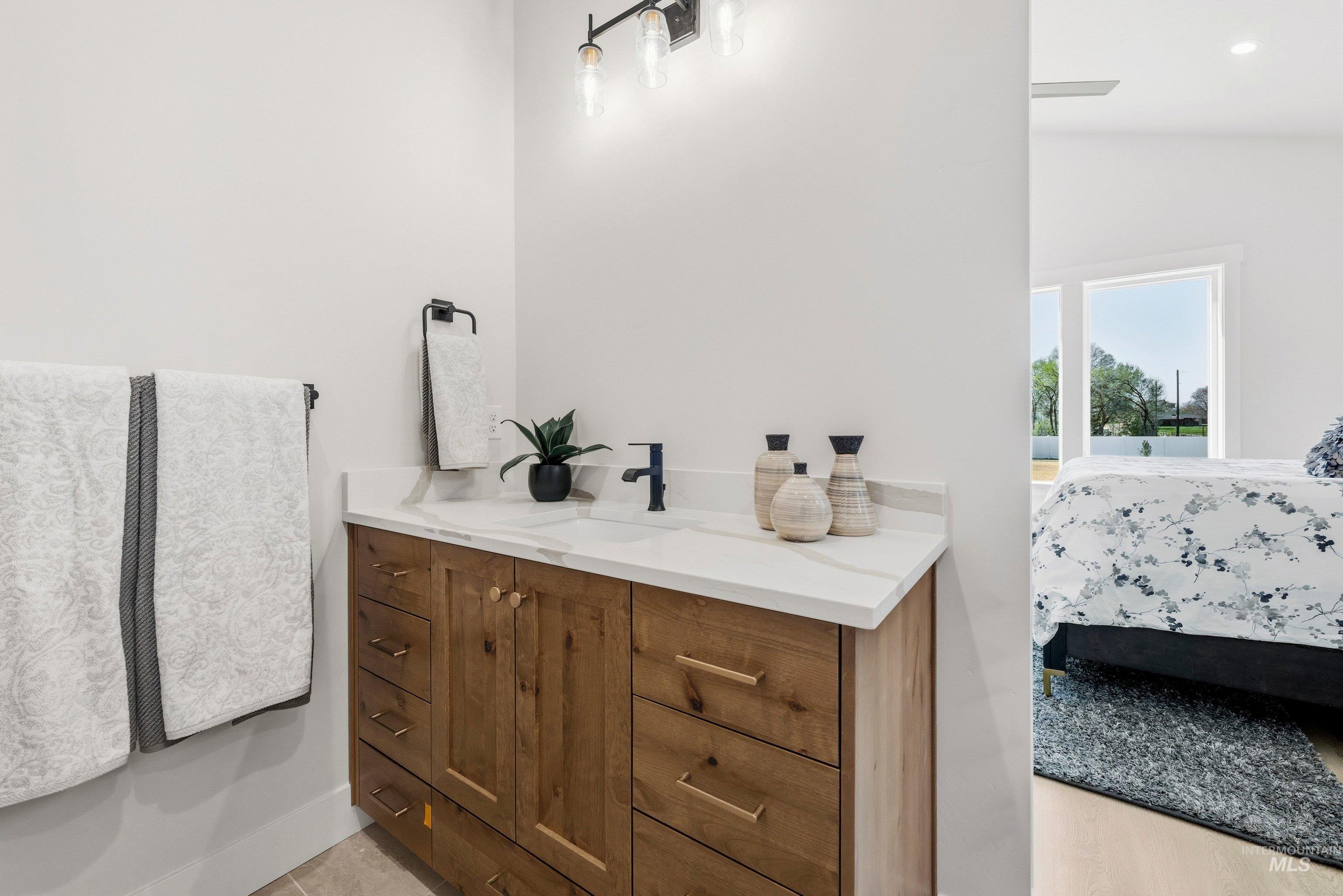 24897 Ardmore Court Caldwell, ID 83607 - Photo 40 of 47 Bathroom with vanity and ensuite bathroom
