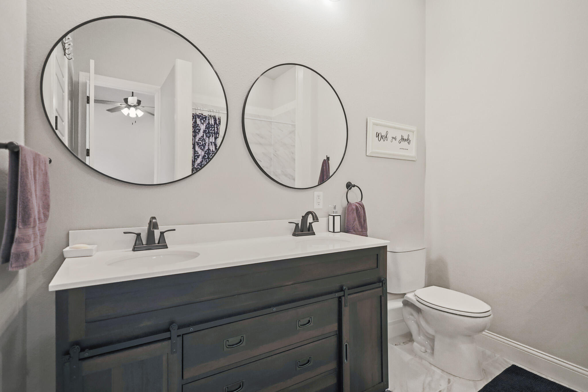 301 Fagan Road Snyder, TX 79549 - Photo 58 of 102 a bathroom with a toilet a sink and a mirror