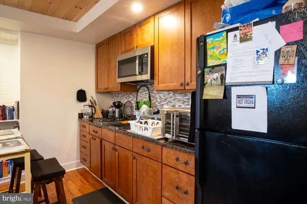 a kitchen with stainless steel appliances a sink stove and cabinets