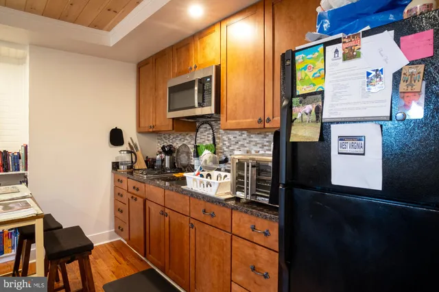 a kitchen with stainless steel appliances a sink stove and cabinets