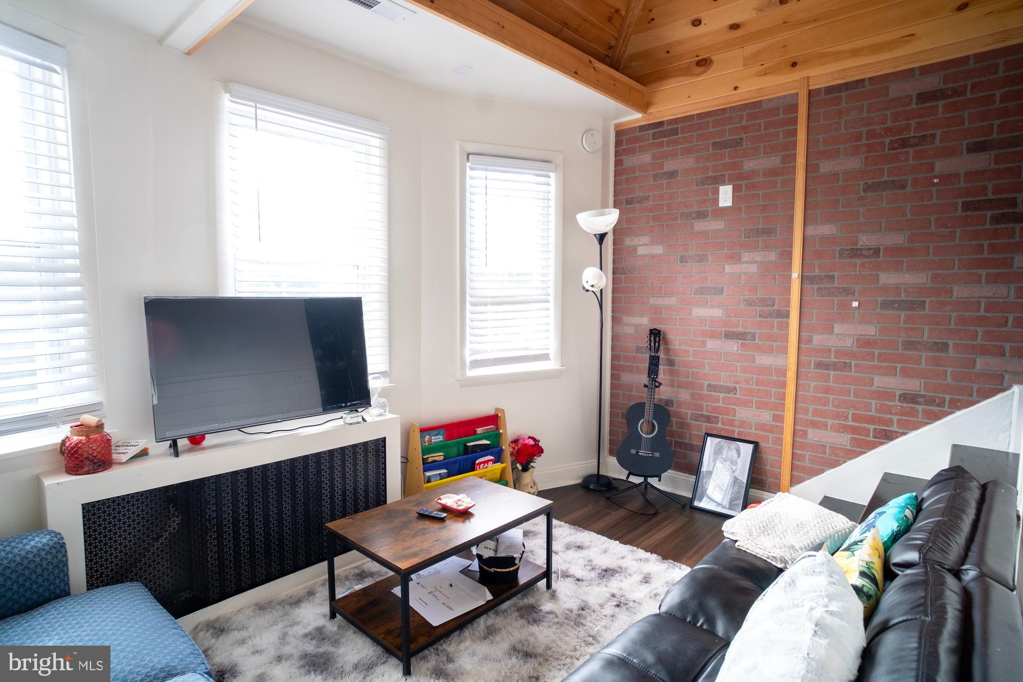 1416 Sulphur Spring Road Halethorpe, MD 21227 - Photo 15 of 42 a living room with furniture and a flat screen tv