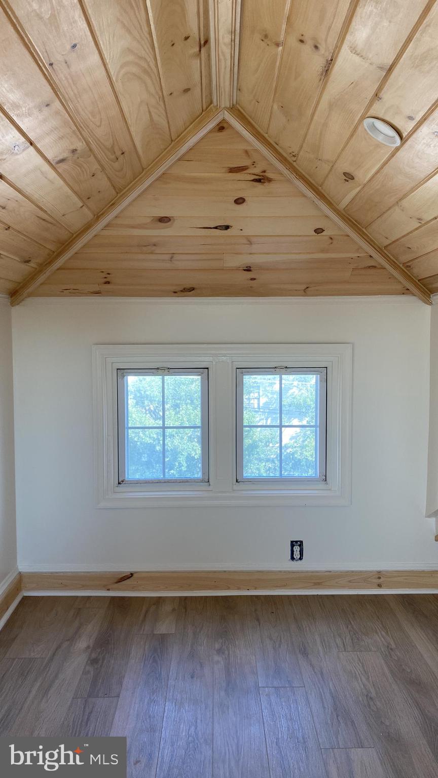 1416 Sulphur Spring Road Halethorpe, MD 21227 - Photo 29 of 42 an empty room with wooden floor and windows