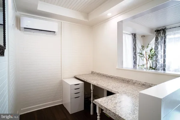 a bathroom with a bathtub sink and mirror