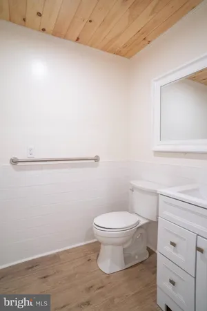 a bathroom with a toilet sink and mirror