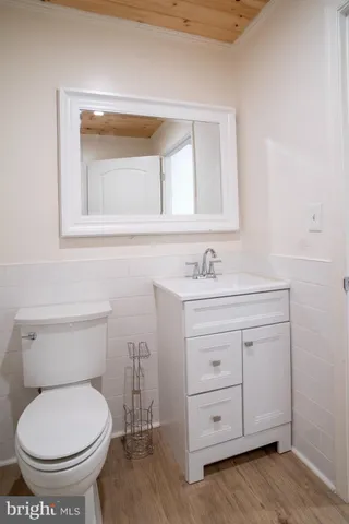 a kitchen with a sink cabinets and wooden floor