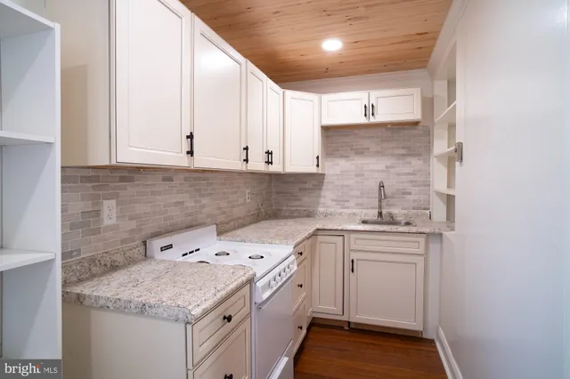 a room with a wooden floor and window
