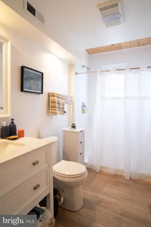 a bathroom with a toilet a sink and a mirror
