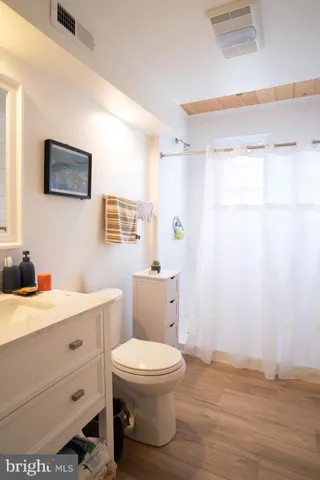 a bathroom with a toilet a sink and a mirror