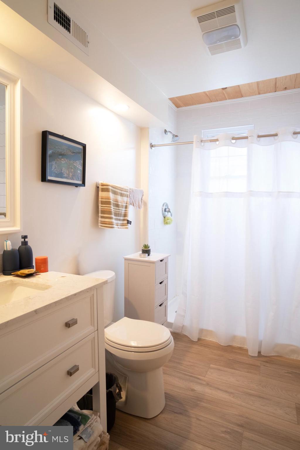 1416 Sulphur Spring Road Halethorpe, MD 21227 - Photo 4 of 42 a bathroom with a toilet a sink and a mirror