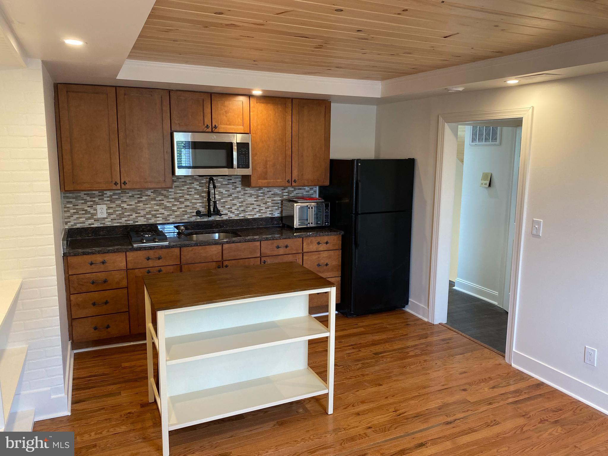 1416 Sulphur Spring Road Halethorpe, MD 21227 - Photo 6 of 42 a kitchen with granite countertop wooden cabinets and refrigerator