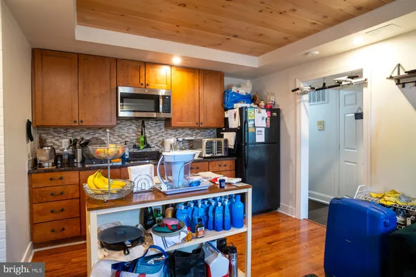 a kitchen with stainless steel appliances granite countertop a refrigerator stove microwave and sink