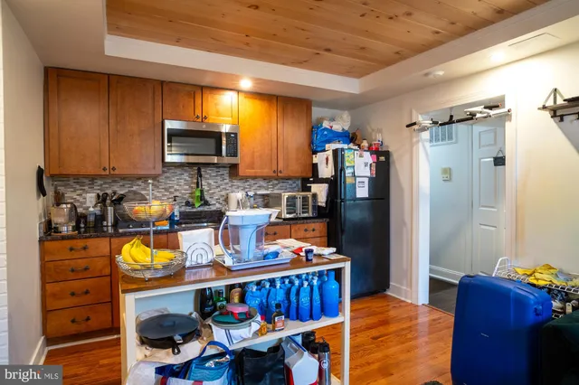 a kitchen with stainless steel appliances granite countertop a refrigerator stove microwave and sink