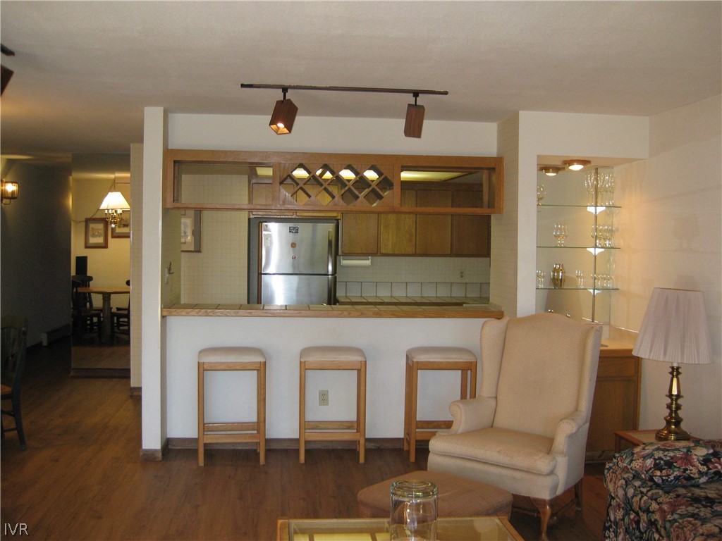 335 Ski Way, Unit 314 Incline Village, NV 89451 - Photo 10 of 15 a living room with a table chairs and a chandelier