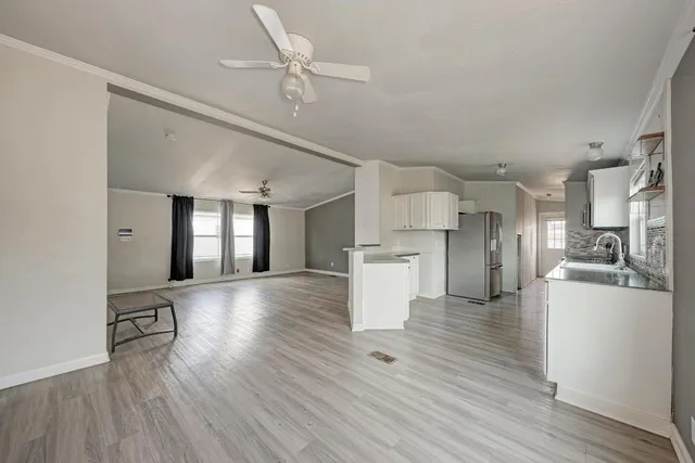 a view of a kitchen with a sink and a refrigerator
