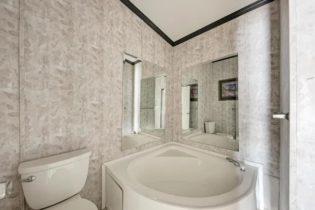 a bathroom with a toilet a sink and bathtub