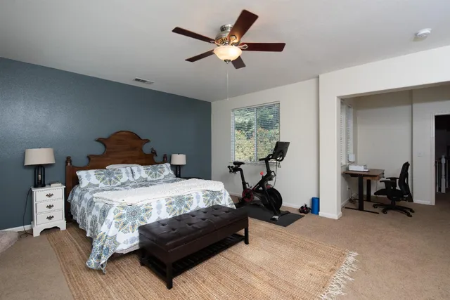 a bedroom with bed and a chandelier