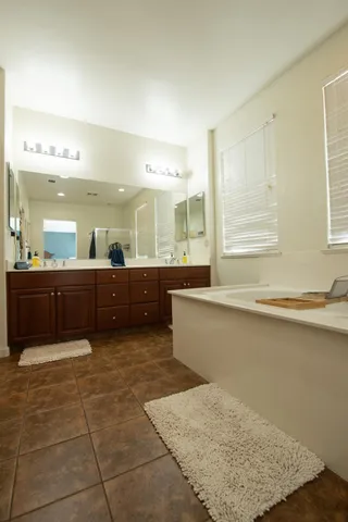 a large bathroom with a large tub and sink