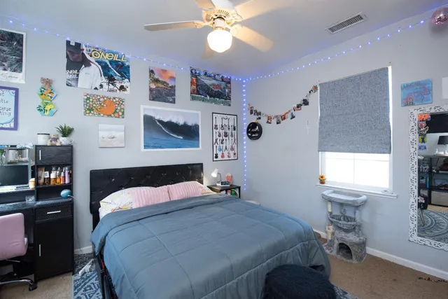 a bedroom with a bed and a window