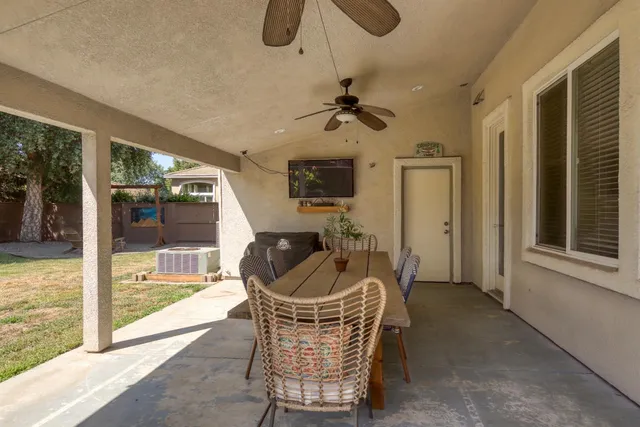 a front view of a house with a yard and outdoor seating
