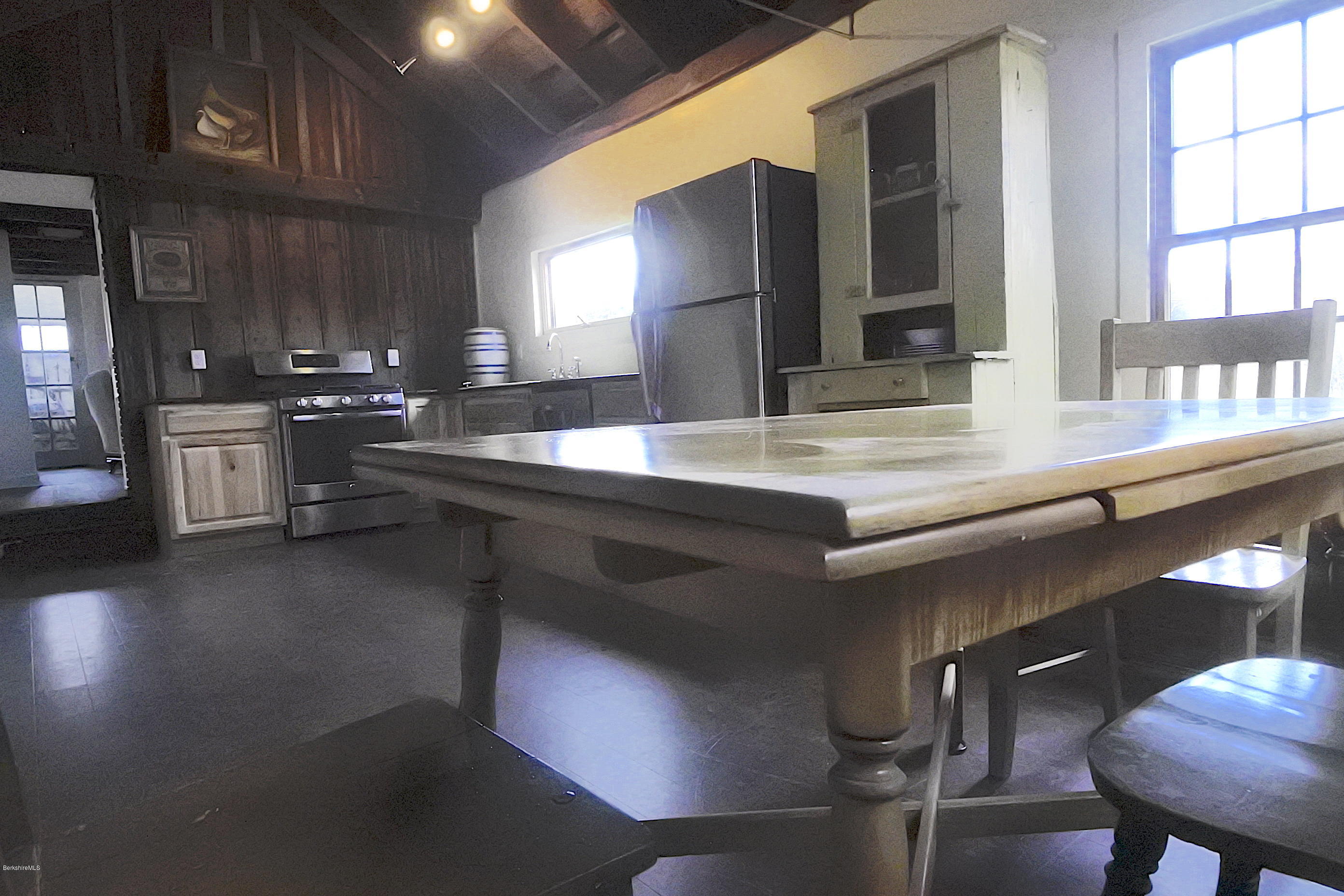 6 West Stockbridge Road Stockbridge, MA 01262 - Photo 3 of 15 a kitchen with kitchen island granite countertop a sink cabinets and wooden floor