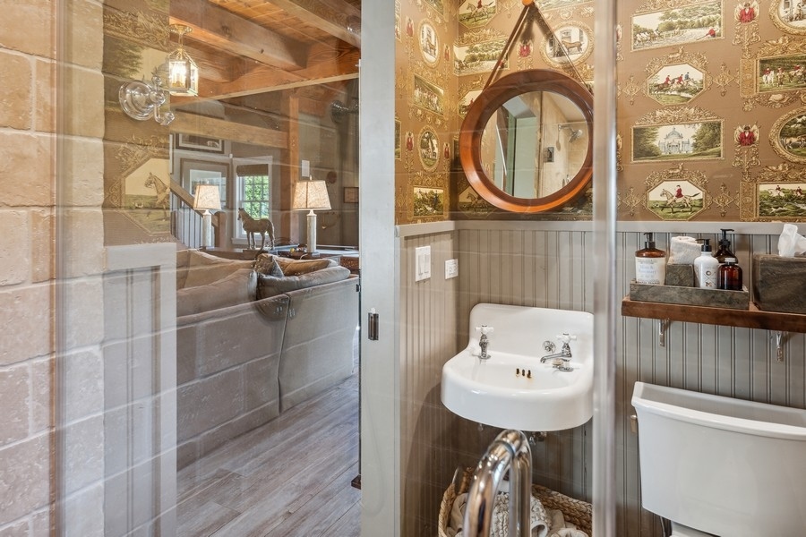 422 Sunset Ridge Road Northfield, IL 60093 - Photo 40 of 52 a bathroom with a sink a mirror and a toilet