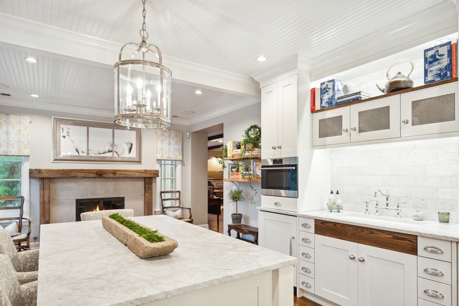 422 Sunset Ridge Road Northfield, IL 60093 - Photo 6 of 52 a kitchen with stainless steel appliances granite countertop a stove oven and a refrigerator with cabinets
