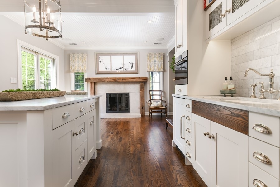 422 Sunset Ridge Road Northfield, IL 60093 - Photo 8 of 52 a kitchen with granite countertop a sink cabinets stainless steel appliances and a large window