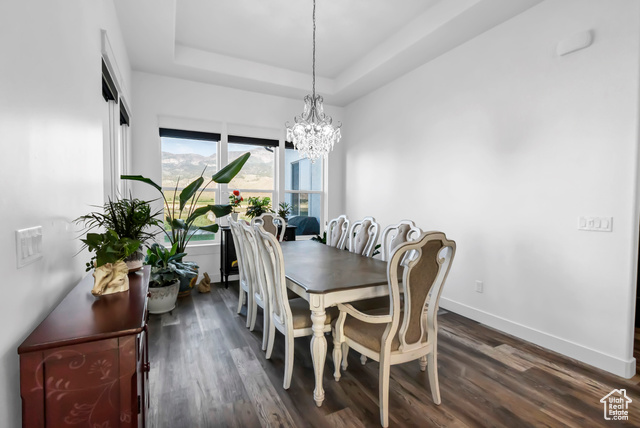1952 Highway 118 Monroe, UT 84754 - Photo 56 of 88 Dining room featuring a tray ceiling, dark wood-style floors, and a chandelier