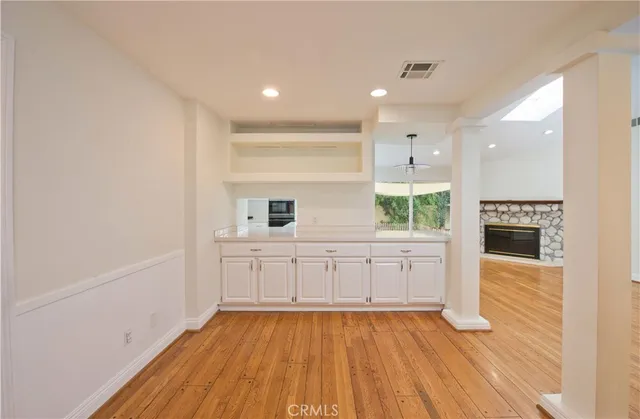 a kitchen with wooden floors and white appliances