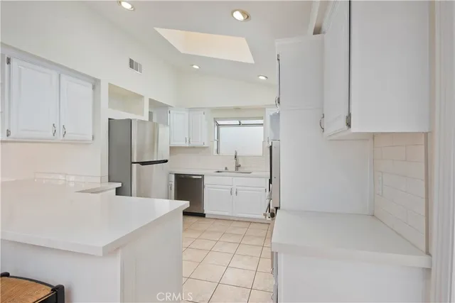 a kitchen with a refrigerator a sink and dishwasher