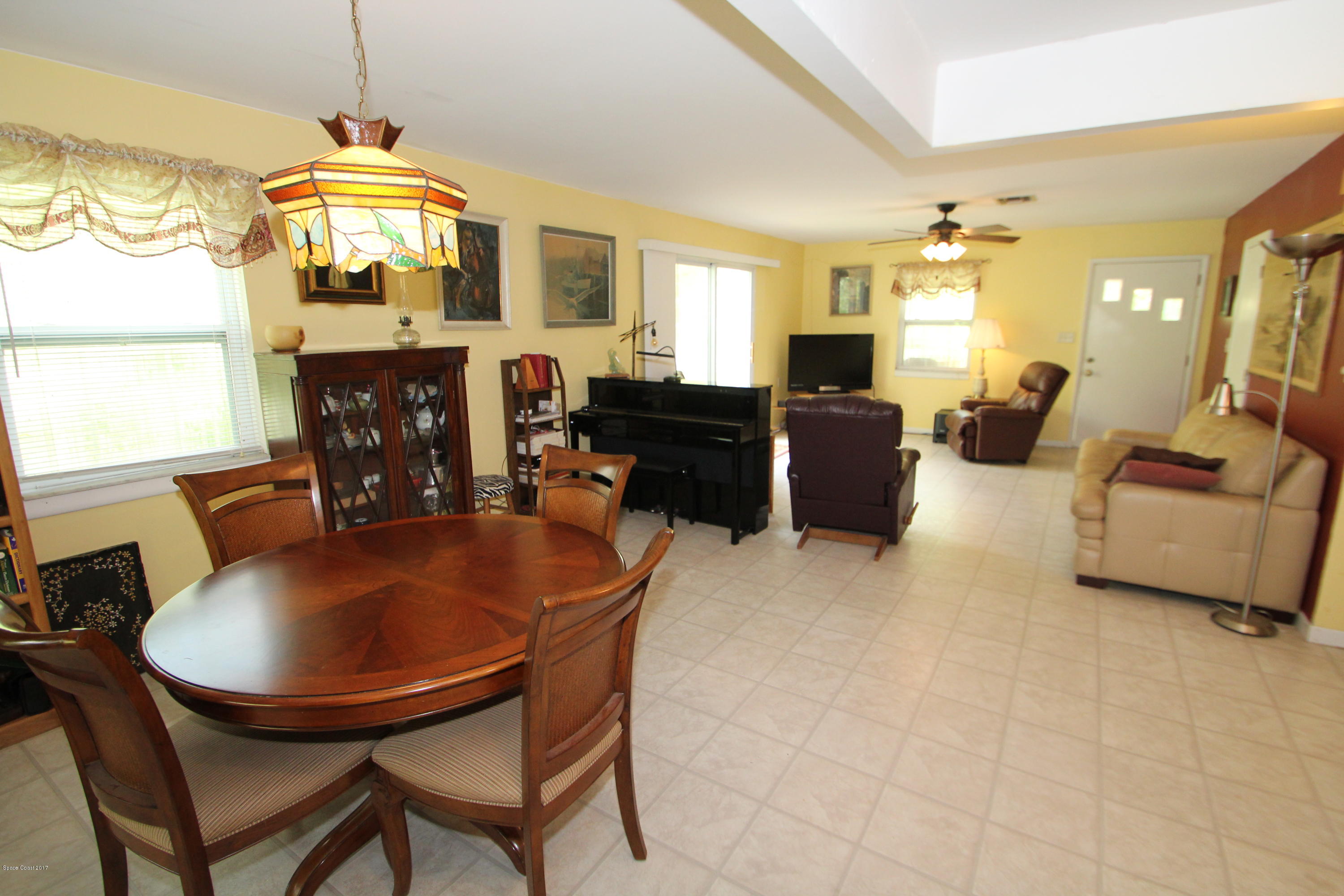 1666 Emmaus Road Northwest Palm Bay, FL 32907 - Photo 5 of 15 a living room with fireplace furniture and a window