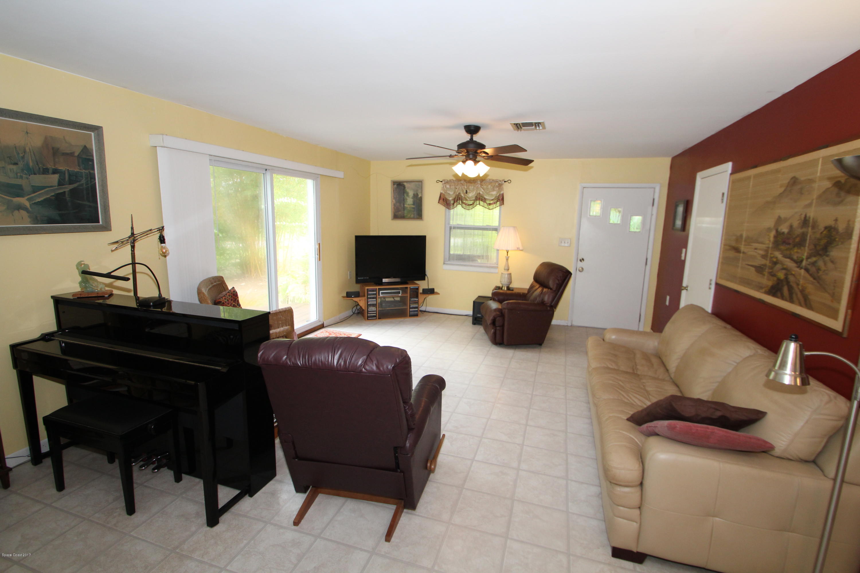 1666 Emmaus Road Northwest Palm Bay, FL 32907 - Photo 6 of 15 a living room with furniture and a flat screen tv