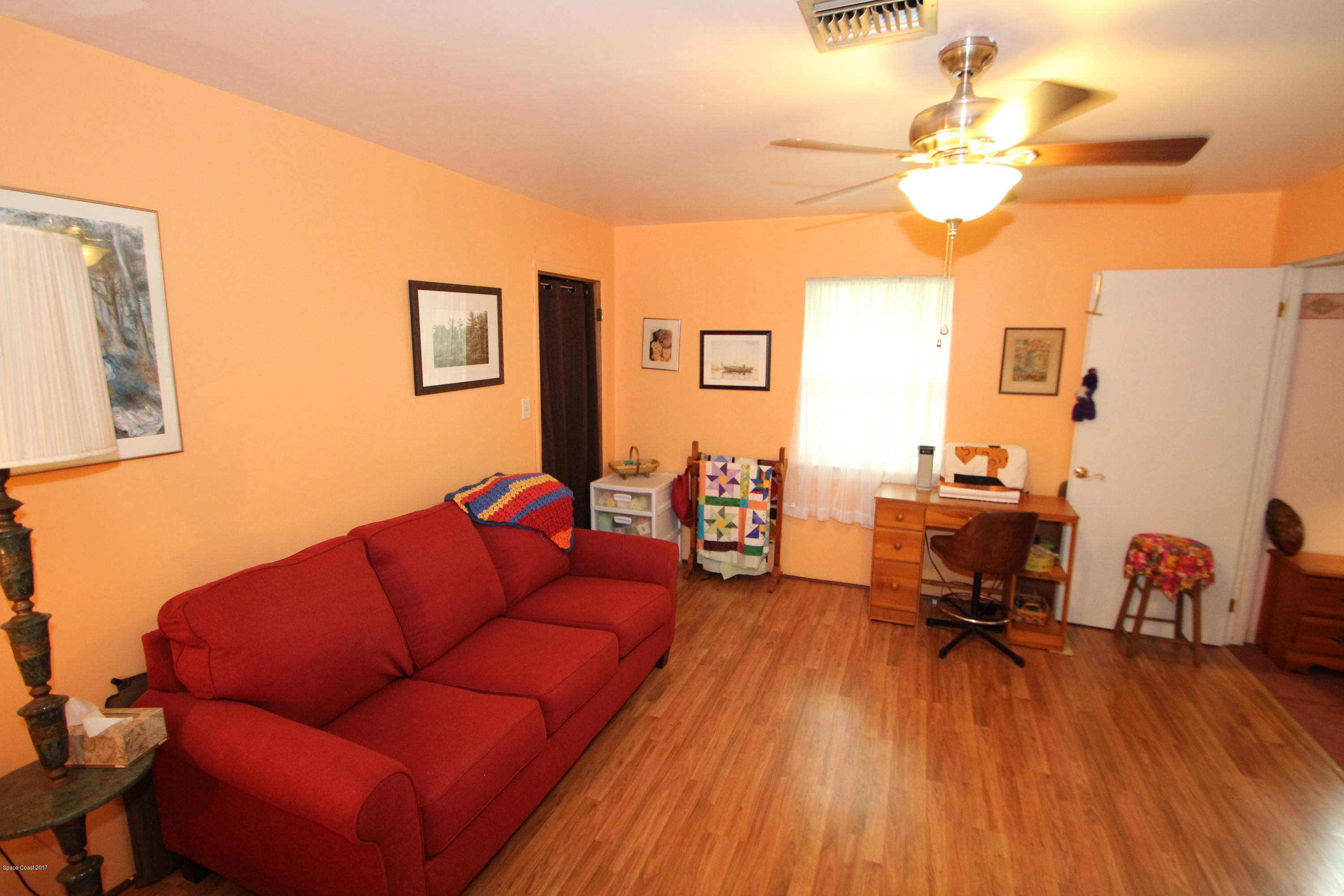 1666 Emmaus Road Northwest Palm Bay, FL 32907 - Photo 7 of 15 a living room with furniture and a wooden floor