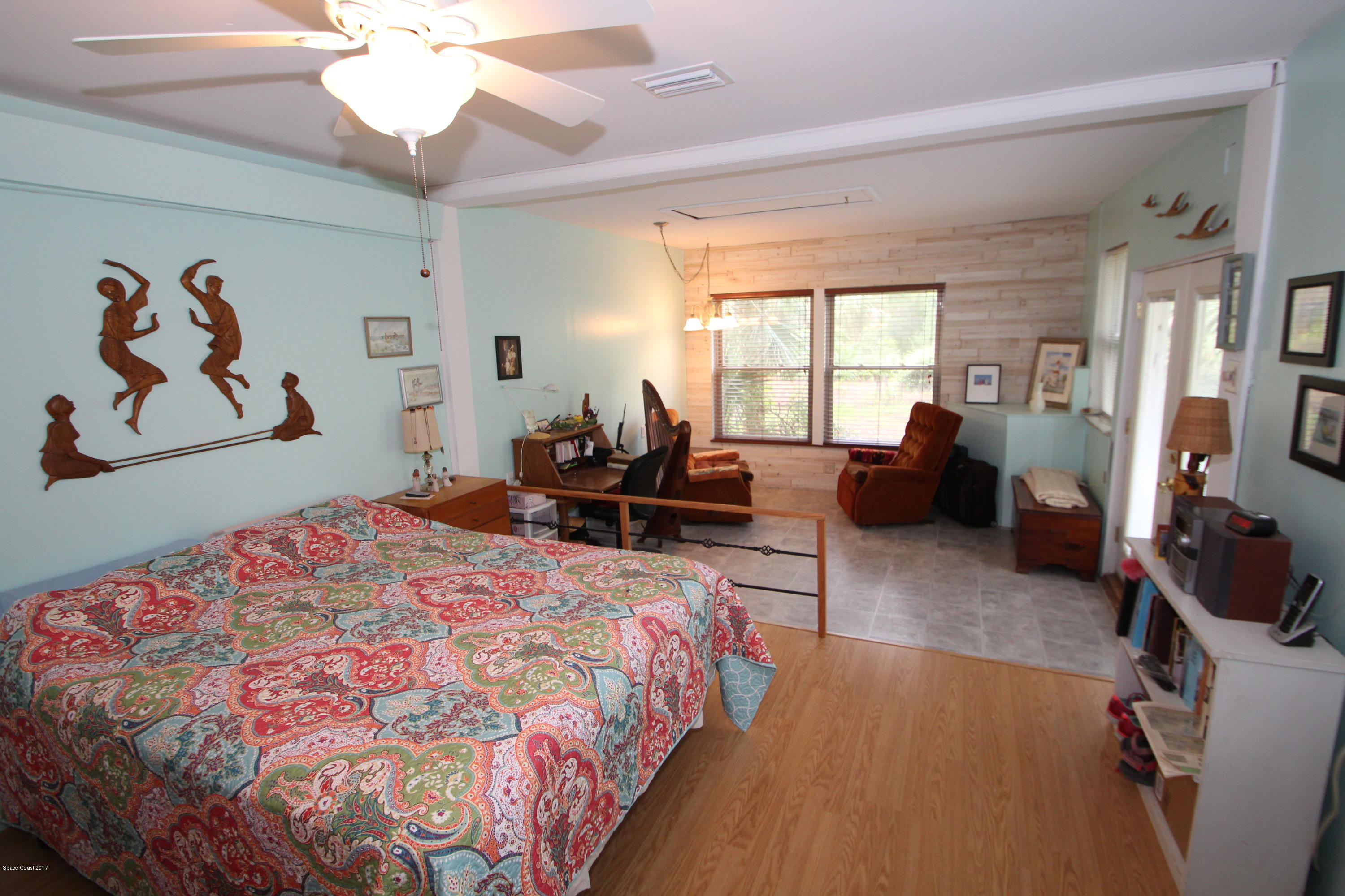 1666 Emmaus Road Northwest Palm Bay, FL 32907 - Photo 9 of 15 a bedroom with a bed and a chandelier
