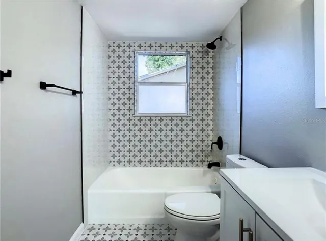 a bathroom with a toilet a sink and bathtub
