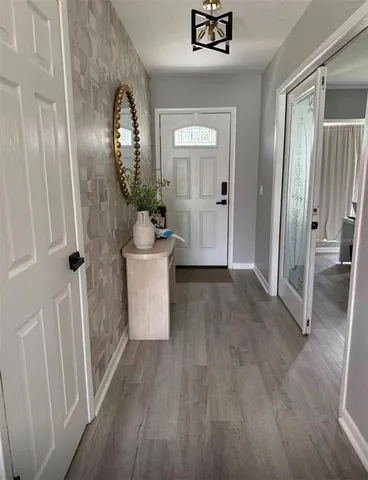 a view of a livingroom with wooden floor and a staircase