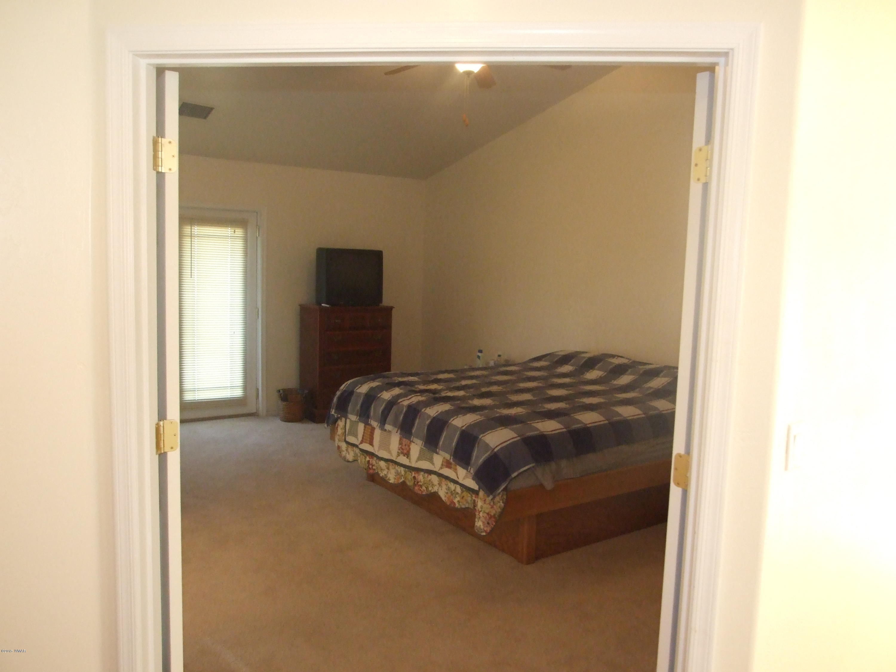 2887 South Bourdon Ranch Road Taylor, AZ 85939 - Photo 19 of 24 a bedroom with a bed and a mirror